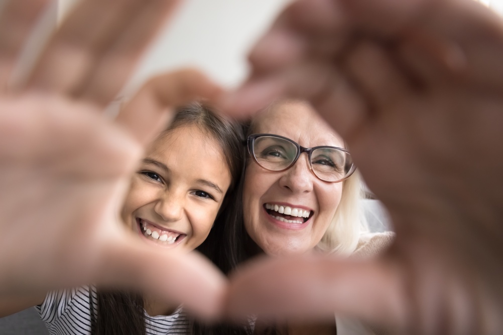 A grandmother and granddaughter smiling together